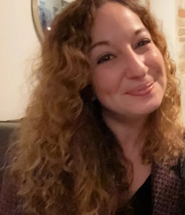 Sarah Herbeth, souriante, cheveux bouclés